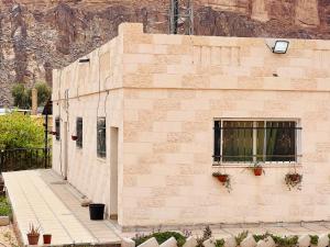 a brick building with plants on the side of it at Wadi rum village bed and breakfast in Wadi Rum +9 photos