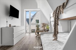 Televiisor ja/või meelelahutuskeskus majutusasutuses Ferienhaus Inselloft Fehmarn