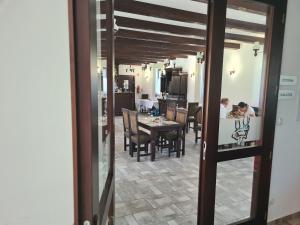 a man sitting at a table in a dining room at ECO RIBELLIUM in Gánt