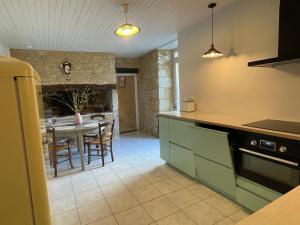 a kitchen with a table and a dining room at Holidayhome for 6 persons at Ferme la Geneste in Coux-et-Bigaroque