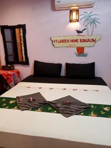 a bed in a room with at P P Garden Home Bungalow in Phi Phi Don