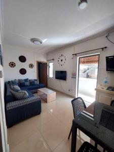 a living room with a blue couch and a tv at New chic apartment Flic en flac in Flic-en-Flac +15 photos