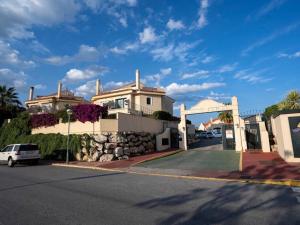 a house on a street with a car parked in front at Holidays2Riviera, Villa 4 bedrooms & 3 bathrooms & Terraces & Jacuzzi & Pool in Mijas