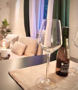 een wijnglas op een tafel naast een fles bij W83 Como Lake House in Como