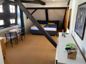 1 dormitorio con 1 cama, mesa y sillas en Haus der Begegnung en Schieder-Schwalenberg