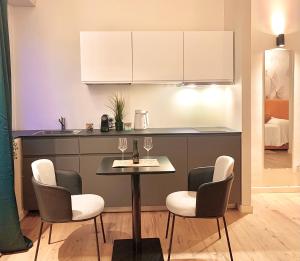 a kitchen with a table with wine glasses on it at W83 Como Lake House in Como