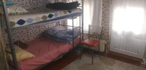a dorm room with a bunk bed and a chair at Men's Hostel in Fatih, Istanbul in Istanbul