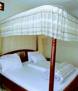a bedroom with a canopy bed with two beds at Kampala Ntinda Comfy Holiday Home in Kampala