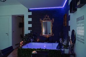 a large bath tub in a room with a mirror at Palmina's Apartments in Brindisi