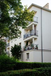 an apartment building with balconies and trees at Kairos Apartments - City - darmowy Parking, ścisłe centrum in Katowice