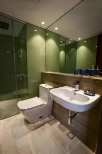 a bathroom with a toilet and a sink and a shower at Vortex Klcc Penthouse Twins Tower View in Kuala Lumpur