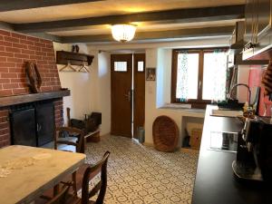 a kitchen with a fireplace and a table and chairs at Casa dell'Arte in Lugano