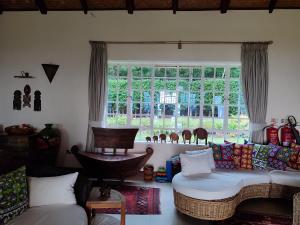 a living room with a couch and a window at Kisuri Resort in Sena
