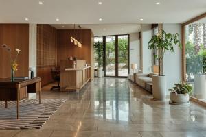 a lobby with a reception desk and a table at Golden Sun Hotel in Athens