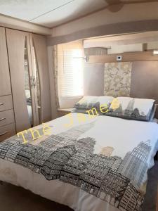 a bedroom with a bed with the words the city on it at The James Lodge in Little Clacton