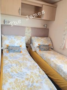 two beds sitting next to each other in a bedroom at The James Lodge in Little Clacton
