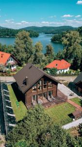 an overhead view of a house with a lake at Marina Olchowiec - Villa in Olchowiec