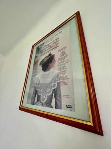 a framed picture of a woman on a wall at studio 30m2 in Arles