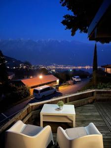 a patio with a table and chairs and a view of a city at Casita di Ellinor in Tignale
