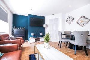 a living room with a blue accent wall at Grandeur 3 Bedroom Flat in London, Mayfair HY3 in London