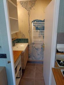a small bathroom with a sink and a sink at Appartement, place Morny. in Deauville