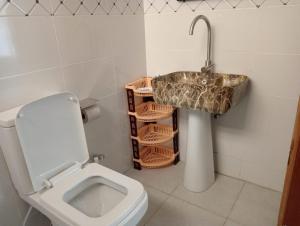 a bathroom with a sink and a toilet at BomaBnB Holiday Homes in Nairobi