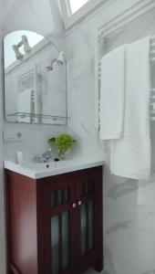 a bathroom with a sink and a mirror at Apartamento Villalvaro con parking in Santander