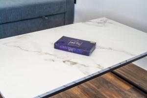 a bar of purple soap sitting on a white marble table at 4 West London Brand New Loft in London