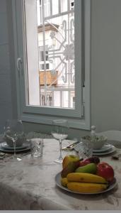 a plate of fruit on a table with a window at Vivienda Villalvaro in Santander