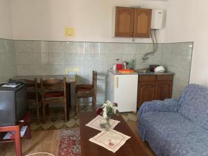 a living room with a couch and a kitchen at Nature in Gacko