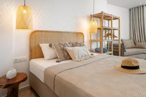 a bedroom with a large bed and a chair at LA MER Suite 2 in Matala