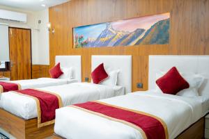 a hotel room with two beds and a painting on the wall at Hotel Palazzo in Kathmandu