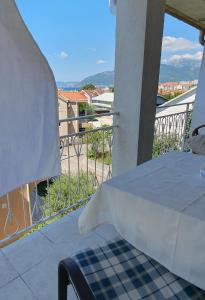 einen Balkon mit einem Bett und Stadtblick in der Unterkunft Apartments Maxim in Tivat