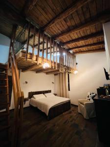 a bedroom with a large bed and a wooden ceiling at B&B FANCHETTI 1938 in Sondrio