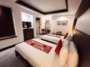 Postel nebo postele na pokoji v ubytování City Inn Vientiane