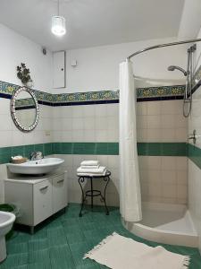 a bathroom with a sink and a tub and a toilet at Il Ruscello di Casa Teresa in Positano