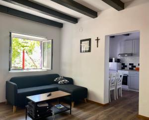 a living room with a couch and a table at La Casa di Nonno in Belej