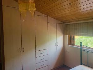 a room with white cabinets and a window at BOKAS EXOTIC HOUSE in Tragána
