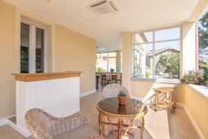 a living room with a table and chairs at B&B Villa Eden jacuzzi pool in Domaso