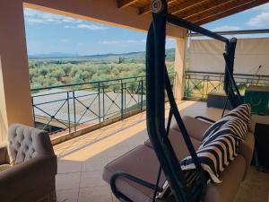 a room with a hammock on a balcony with a view at BOKAS EXOTIC HOUSE in Tragána
