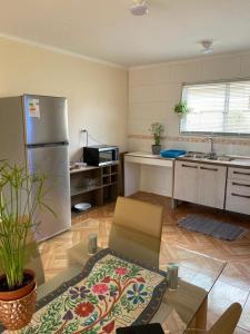 a kitchen with a refrigerator and a table in it at Casa para 4 personas, en El Quisco Norte in El Quisco