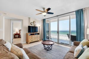 a living room with a couch and a flat screen tv at Island Princess 414 in Fort Walton Beach