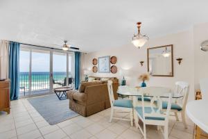 a living room with a table and a couch and a dining room at Island Princess 414 in Fort Walton Beach