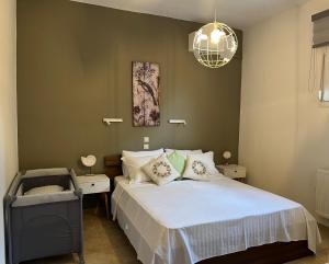 a bedroom with a bed and a chandelier at Kastri Treehouse in Nikiti