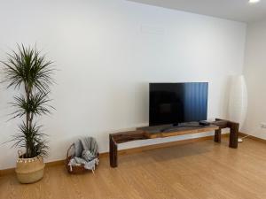 a living room with a flat screen tv on a wall at Casa da Gândara in Ponte de Lima