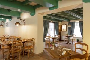 a dining room with wooden tables and chairs at Relais et Chateaux La Bonne Étape in Château-Arnoux-Saint-Auban