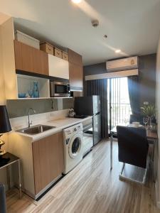 a kitchen with a sink and a washing machine at Seaview condo in Siracha (Free onzen) in Si Racha