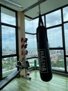 a gym with a punching bag hanging from the ceiling at Seaview condo in Siracha (Free onzen) in Si Racha