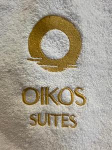 a teddy bear with the word oucos studies on it at Oikos Sani Suites in Sani Beach