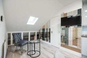 a living room with a chair and a television at Spacious and Modern studio in London G in London